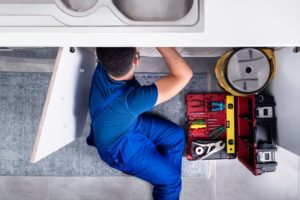 a plumber fixing a drain